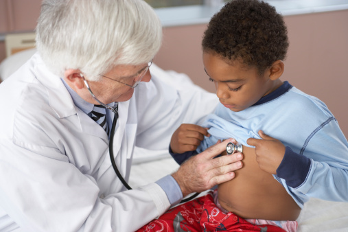 doctor examining child with stethoscope 